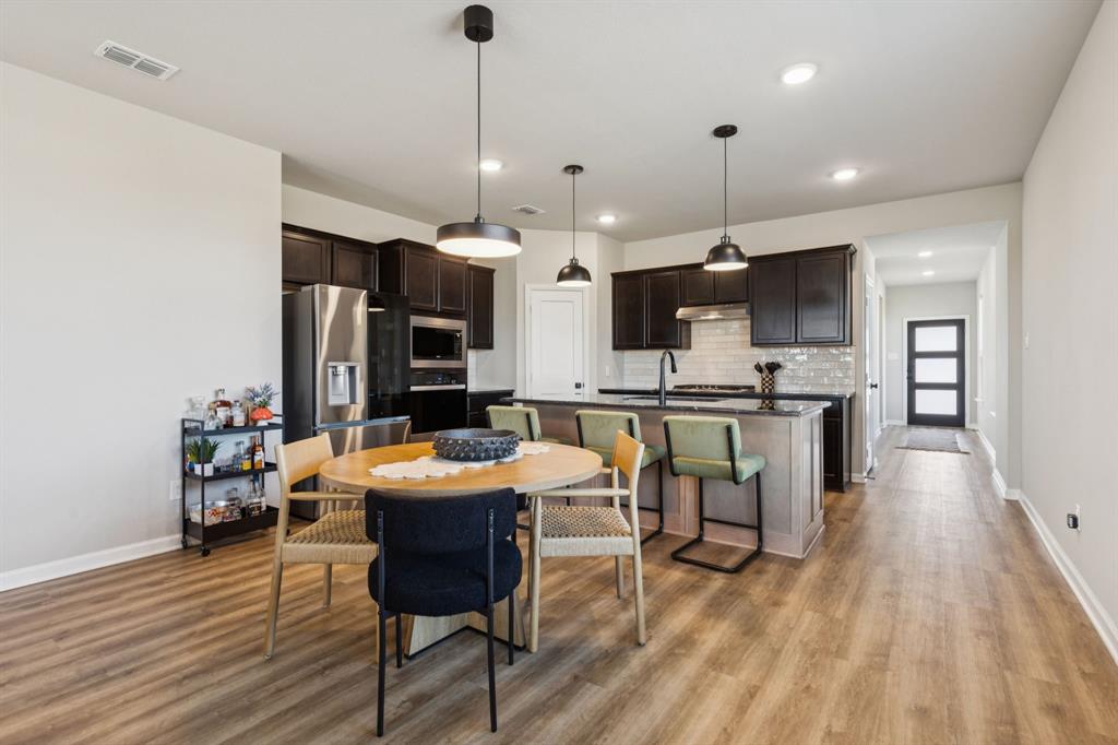 490 Tender Summit Lavon, TX 75166 - Photo 7 of 23 a large kitchen with a table and chairs