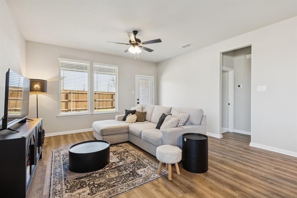 490 Tender Summit Lavon, TX 75166 - Photo 9 of 23 a living room with furniture a flat screen tv and a window