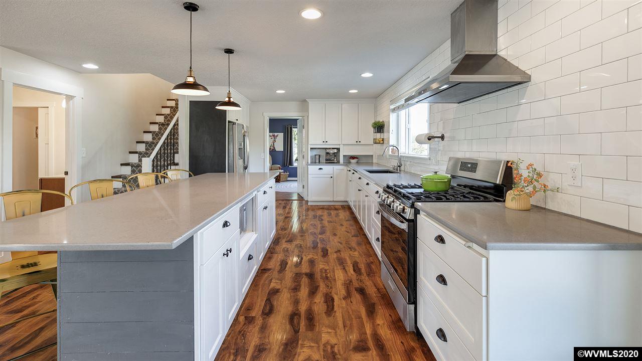 790 Southeast Fir Villa Road Dallas, OR 97338 - Photo 11 of 38 a very nice looking kitchen with a large center island and stainless steel appliances