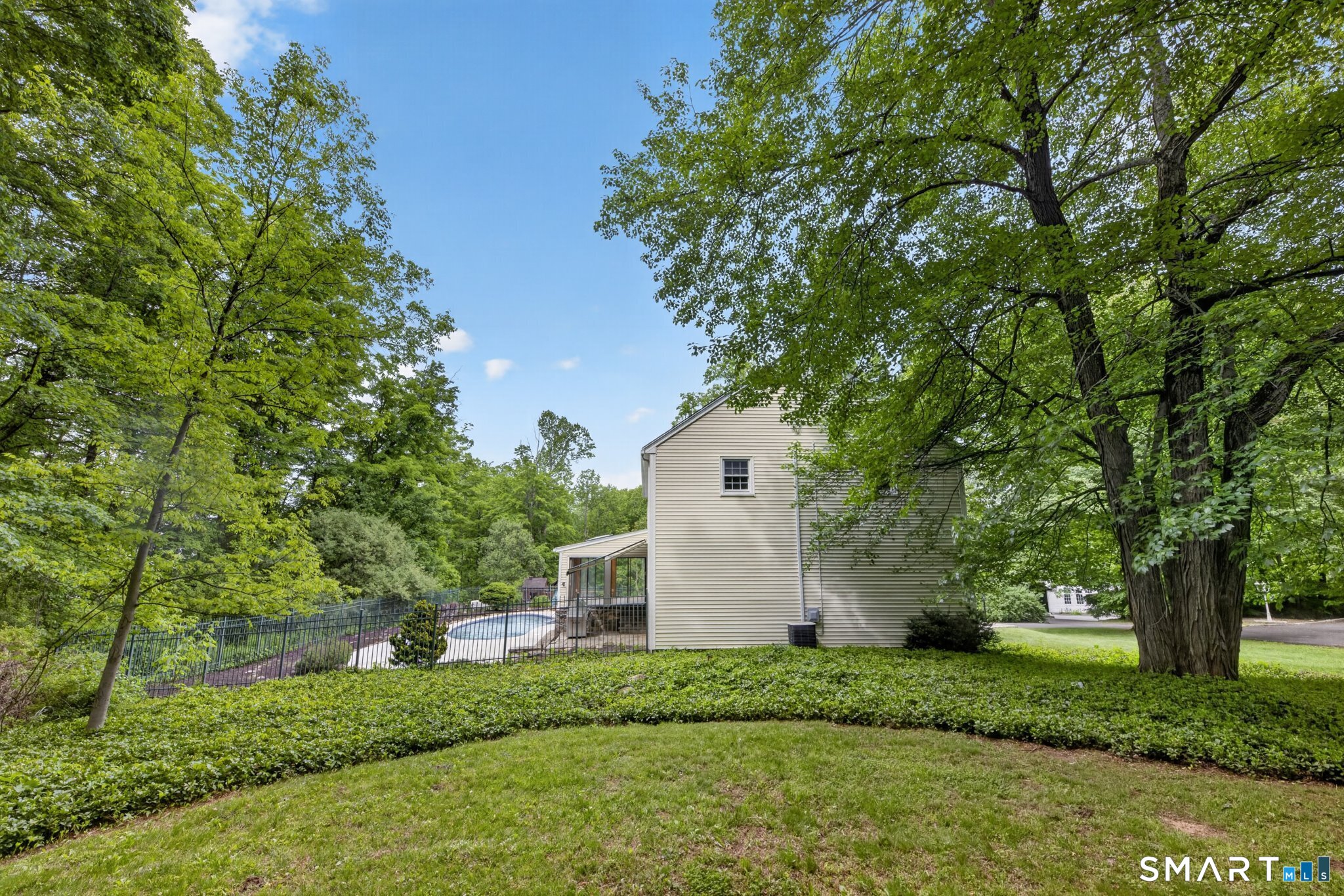 70 Barrack Hill Road Ridgefield, CT 06877 - Photo 27 of 32 a front view of a house with a yard and tree