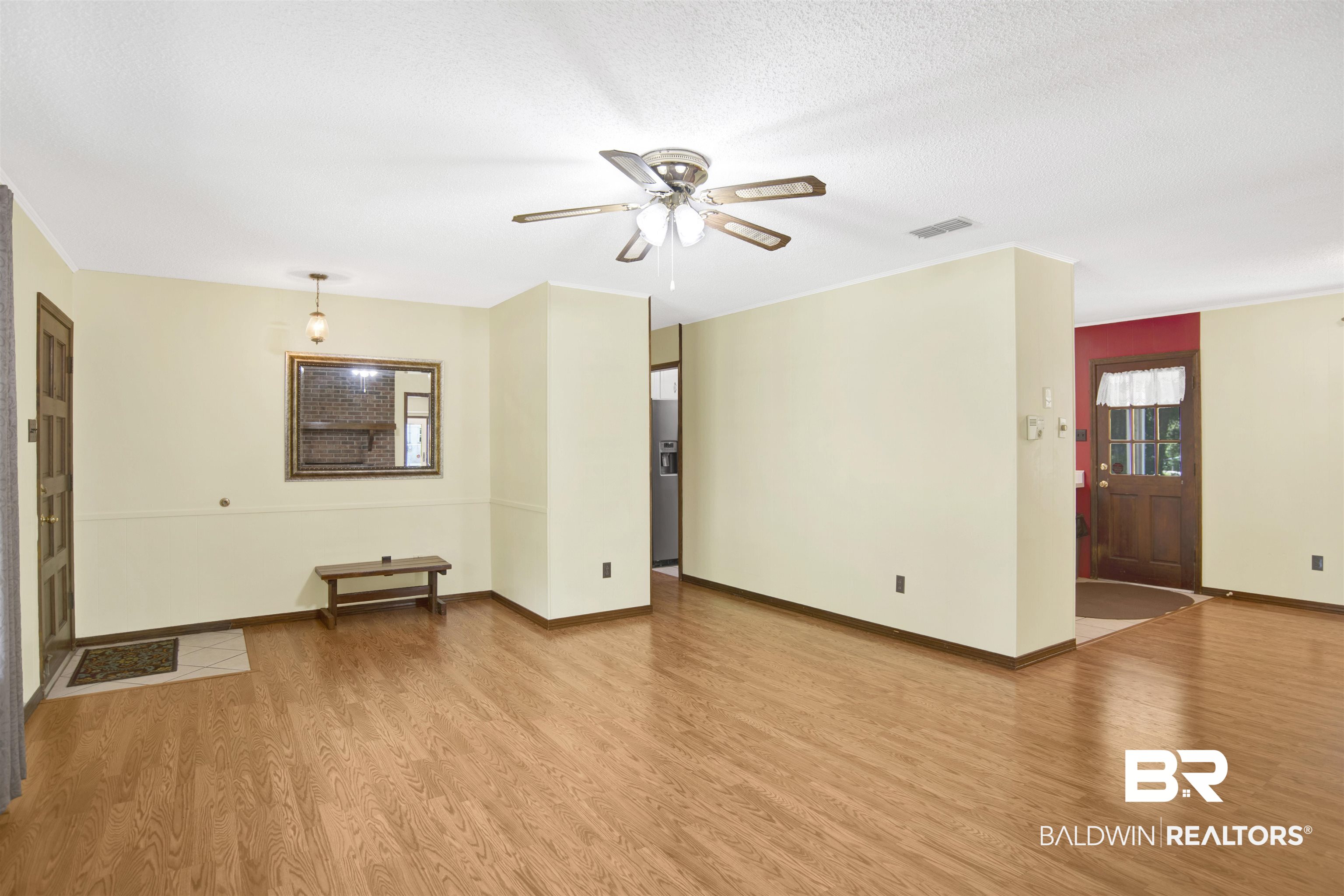 30888 Cemetery Road Daphne, AL 36527 - Photo 11 of 36 Spacious interior featuring wood-finish flooring, a ceiling fan with integrated lighting, and neutral wall tones