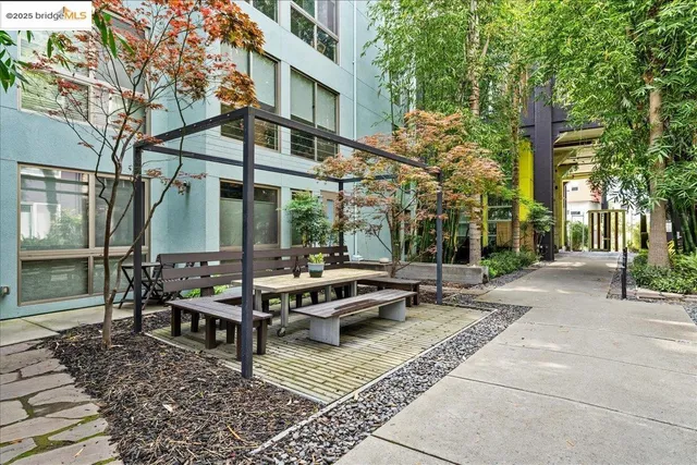 a view of a dinning table and chairs in backyard of the house