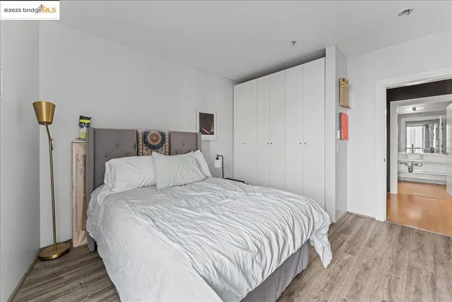 a bedroom with bed and a wooden floor