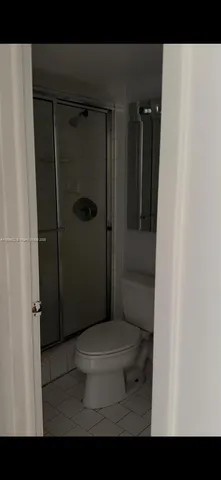 a bathroom with a shower and a toilet