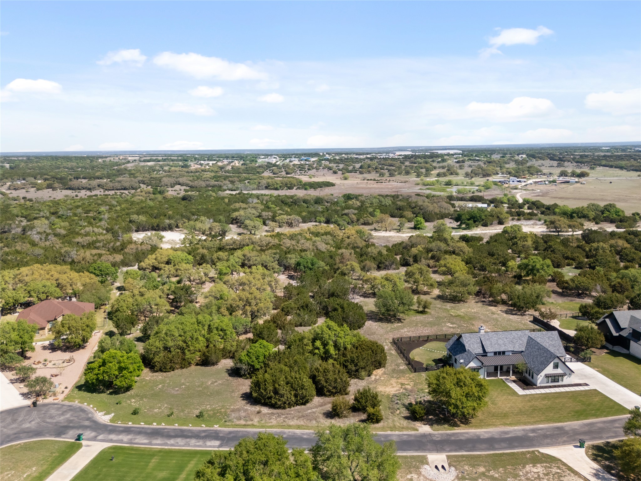 332 First Down Dash Burnet, TX 78611 - Photo 3 of 25 an aerial view of residential houses with outdoor space and trees