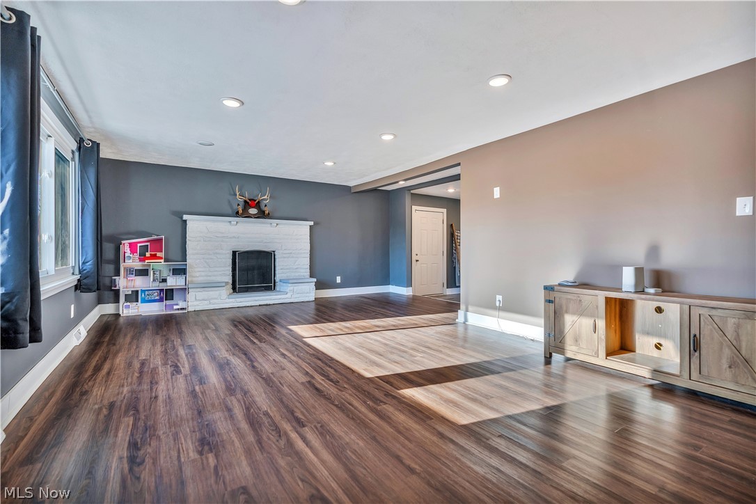 6116 Melody Road Northeast Canton, OH 44721 - Photo 6 of 33 Unfurnished living room featuring dark wood-style flooring, a fireplace, and recessed lighting