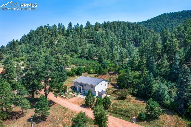 an aerial view of a house with mountain view