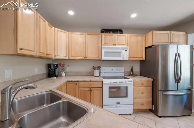 a kitchen with a stove sink and refrigerator