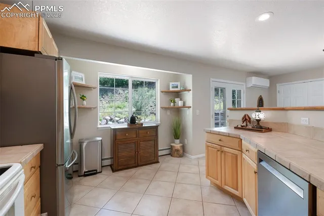 a kitchen with a sink a counter top space and appliances