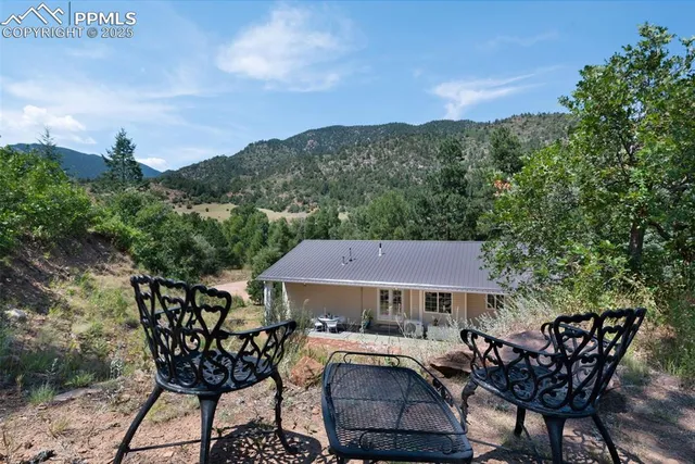 a view of a chairs and table in patio