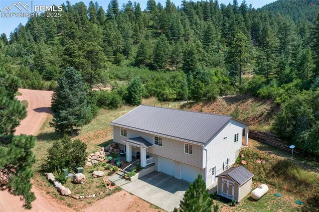 an aerial view of a house with a yard