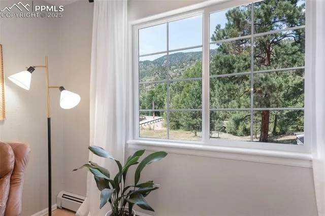 a view of a room with a large window and chair