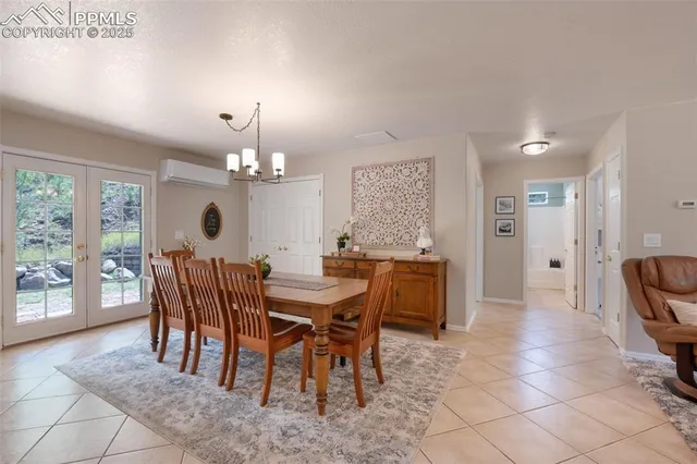 a view of a dining room with furniture and chandelier