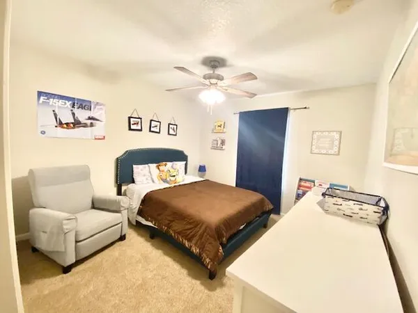 a bedroom with a bed and a couch