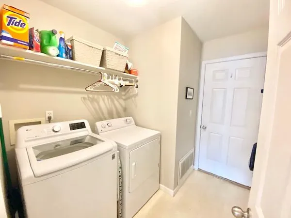 a view of storage and utility room with washer and dryer