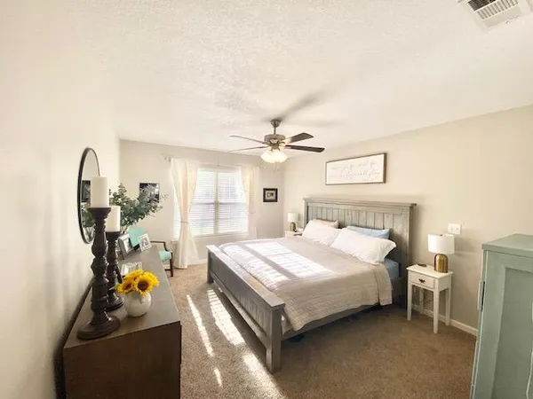 a bed room with a bed mirror and a window