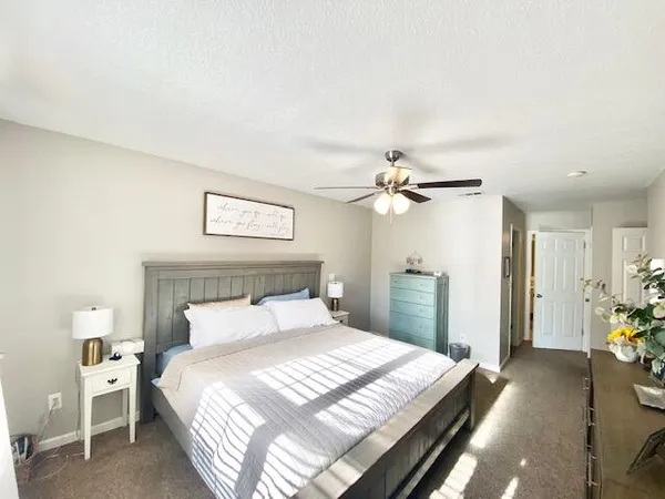 a bedroom with a bed and a chandelier