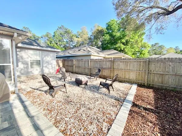 a view of backyard with a patio and outdoor seating