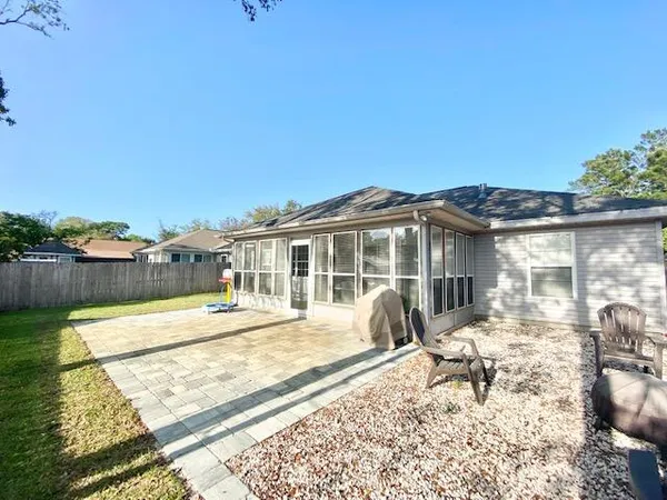 a view of a house with backyard and sitting area