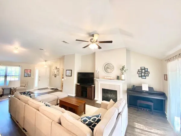 a living room with furniture and a fireplace