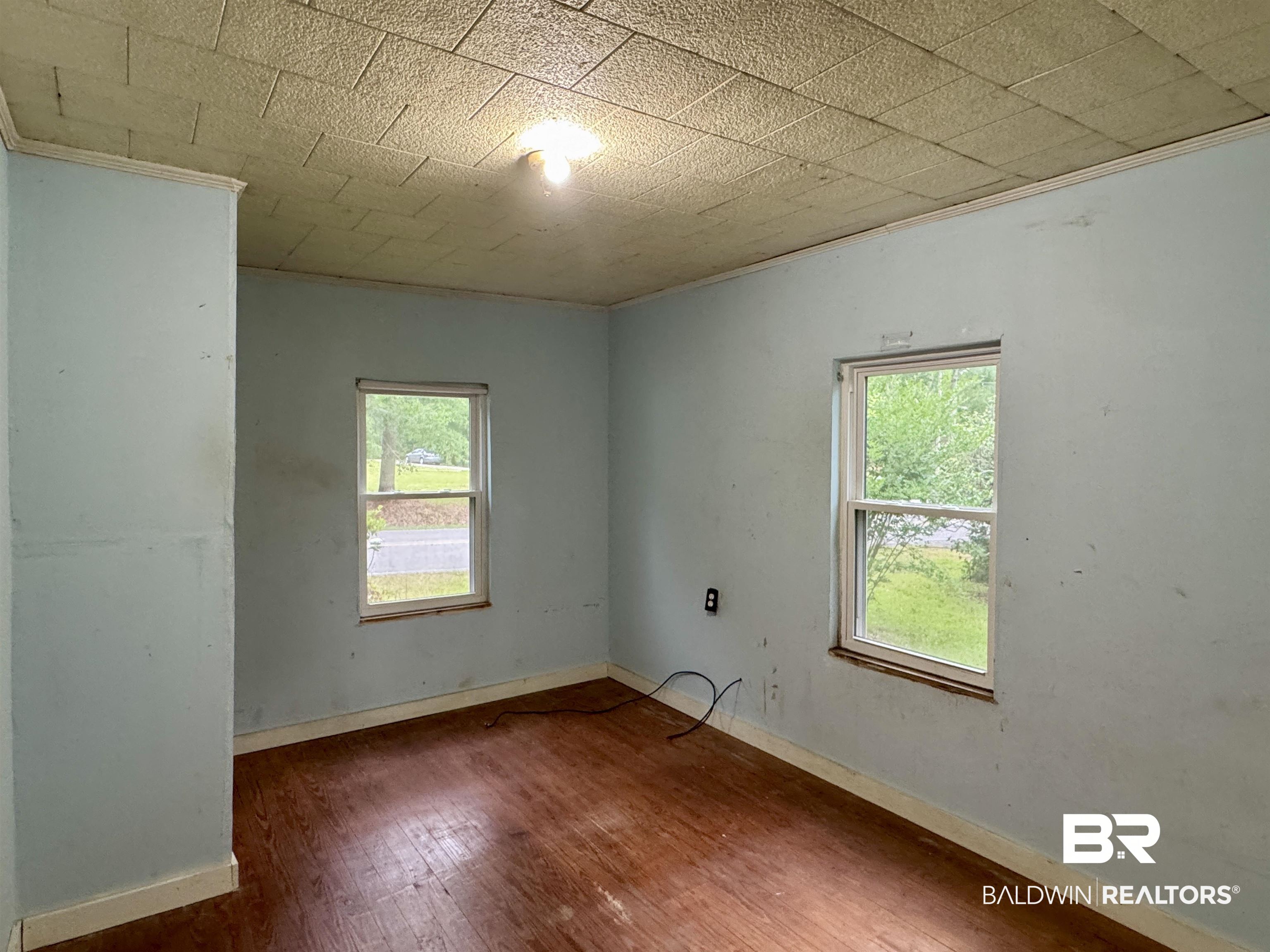 42186 Nicholsville Road Bay Minette, AL 36507 - Photo 8 of 10 Spare room featuring wood finished floors and ornamental molding