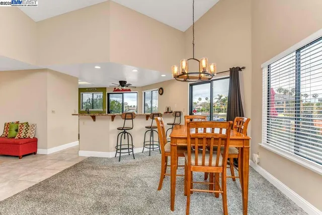 a dining room with furniture and a chandelier