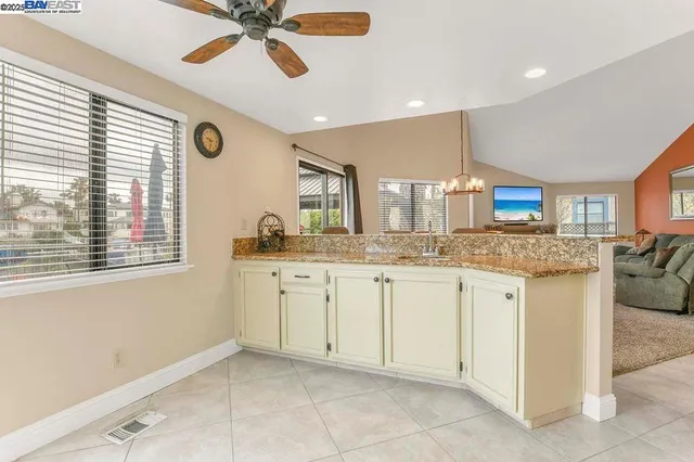a bathroom with a granite countertop sink mirror and cabinets