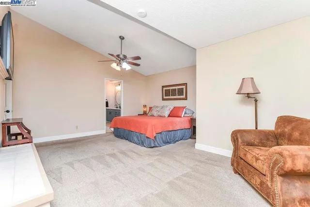 a spacious bedroom with a bed and a couch