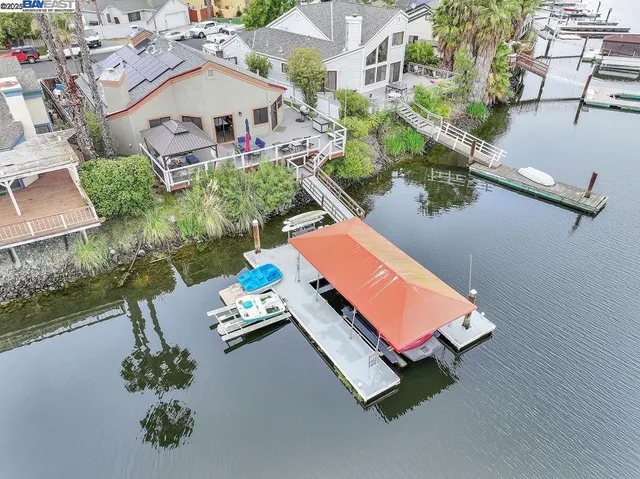 an aerial view of a house with swimming pool and outdoor seating