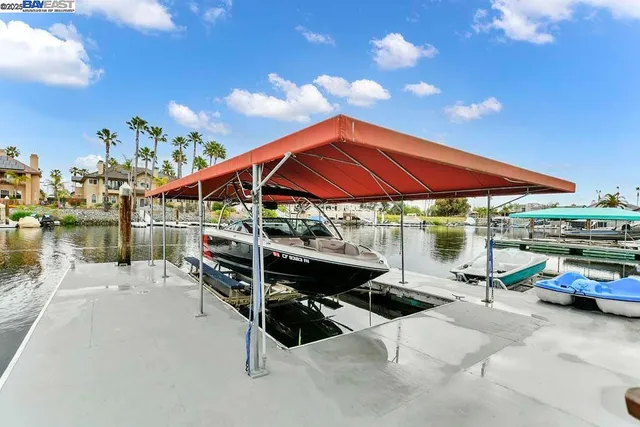 a view of a patio with a table and chairs under an umbrella