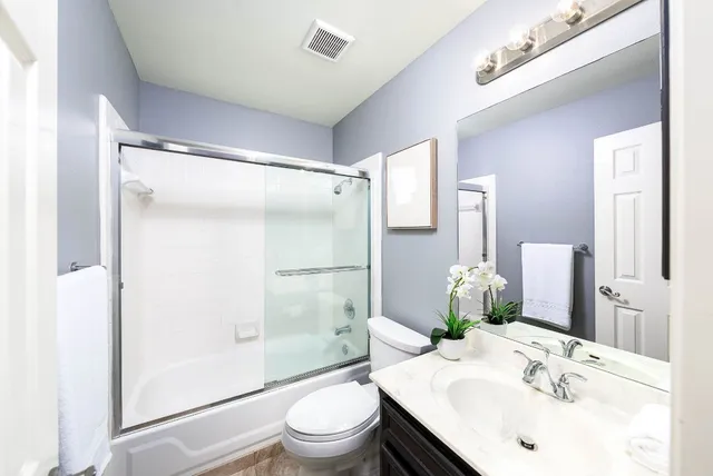 a bathroom with a tub and shower