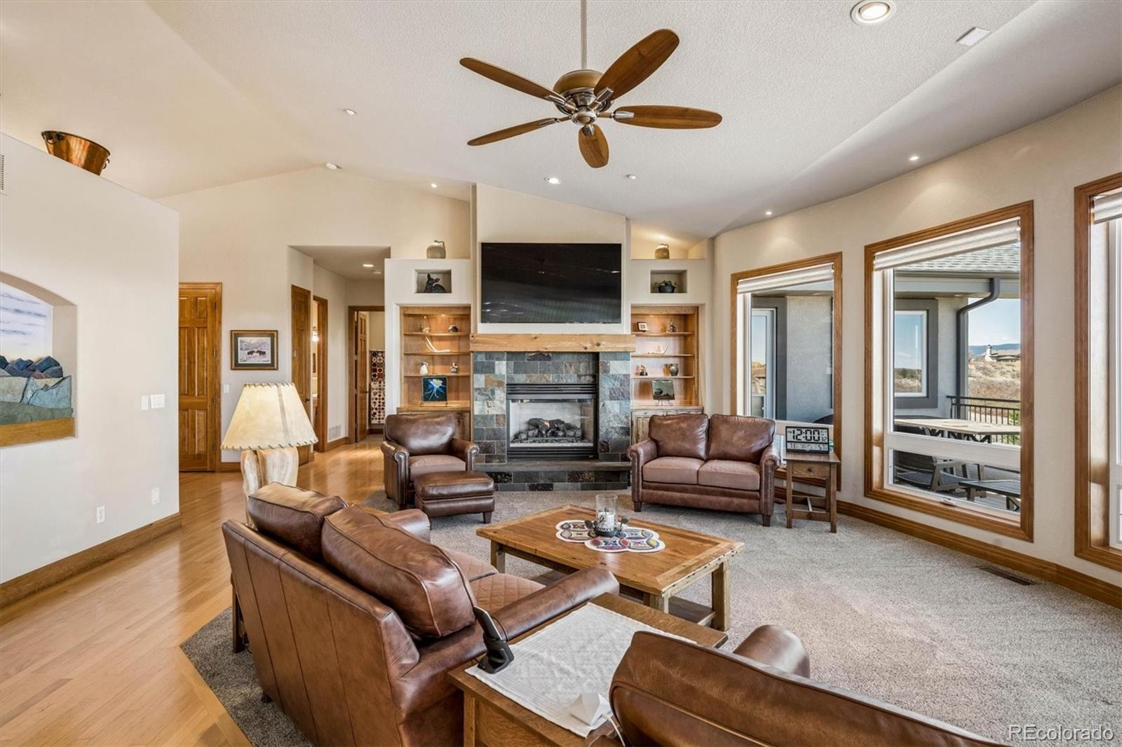 3959 Serenade Road Castle Rock, CO 80104 - Photo 11 of 50 a living room with furniture a fireplace and a flat screen tv