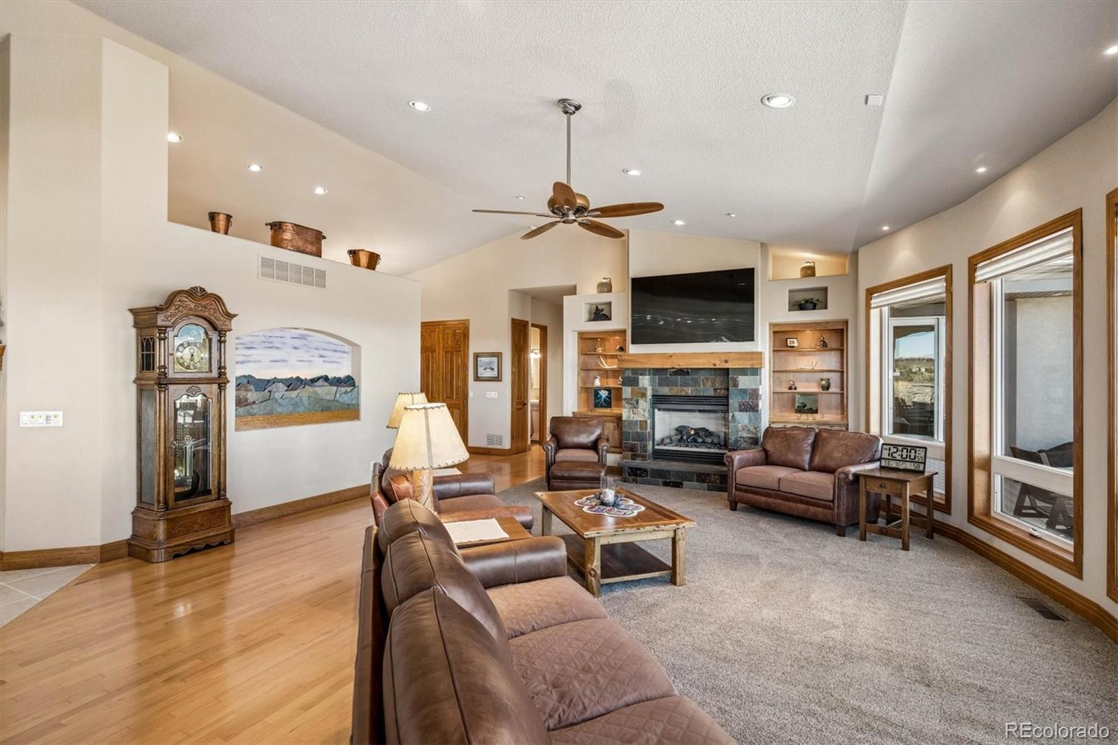 3959 Serenade Road Castle Rock, CO 80104 - Photo 12 of 50 a living room with furniture flat screen tv and a fireplace