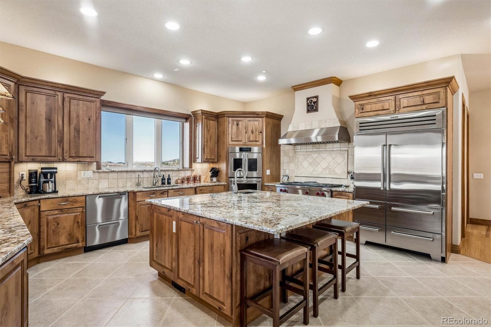 3959 Serenade Road Castle Rock, CO 80104 - Photo 14 of 50 a kitchen with cabinets and wooden floor