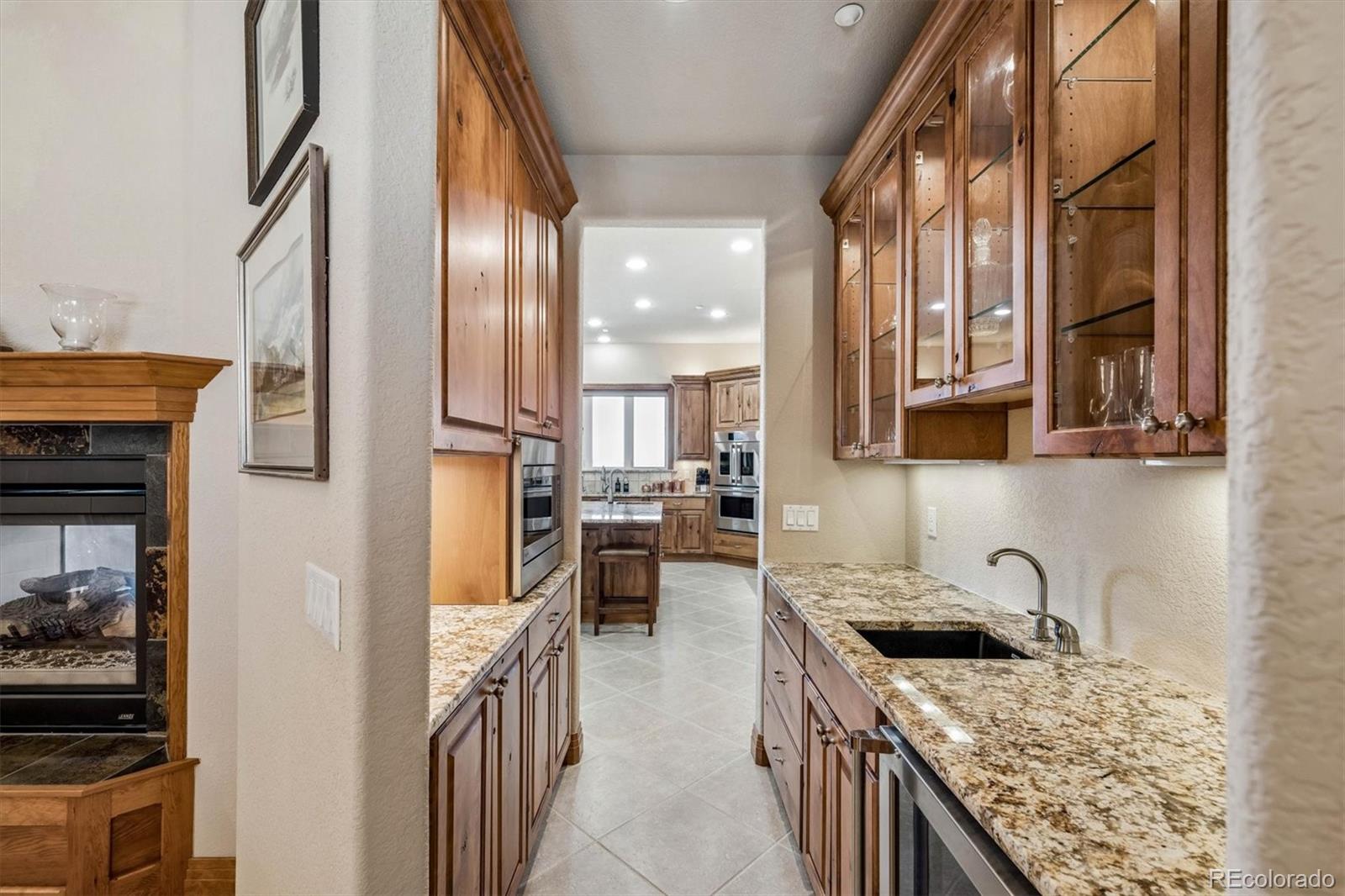 3959 Serenade Road Castle Rock, CO 80104 - Photo 20 of 50 a kitchen with stainless steel appliances granite countertop a stove a sink and a refrigerator
