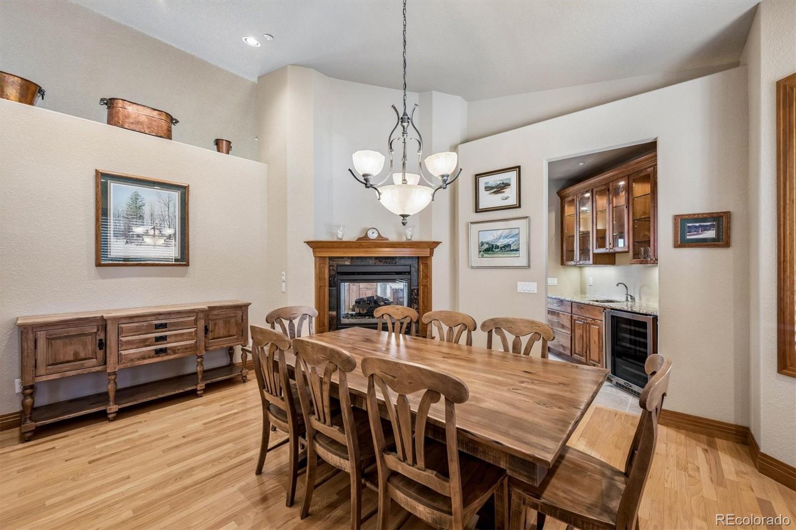 3959 Serenade Road Castle Rock, CO 80104 - Photo 21 of 50 a view of a dining room with furniture a chandelier and wooden floor