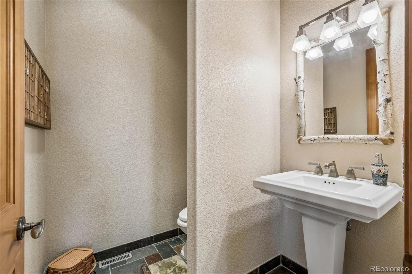 3959 Serenade Road Castle Rock, CO 80104 - Photo 24 of 50 a bathroom with a sink and a mirror