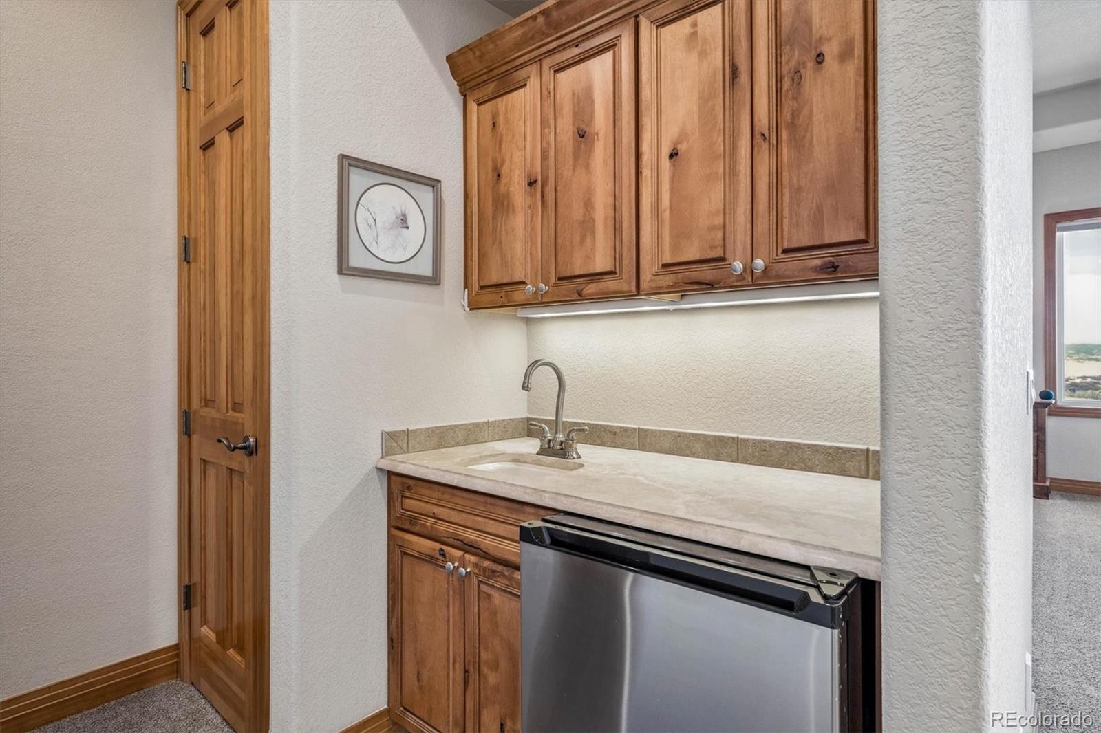 3959 Serenade Road Castle Rock, CO 80104 - Photo 27 of 50 a sink with a wooden floor