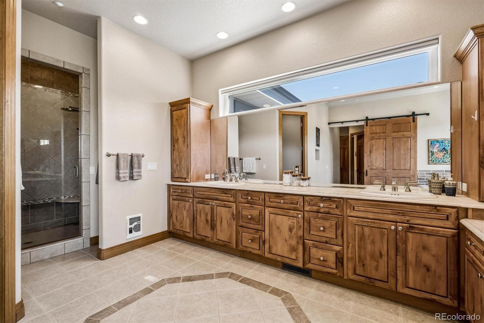 3959 Serenade Road Castle Rock, CO 80104 - Photo 28 of 50 a spacious bathroom with a granite countertop sink and mirror