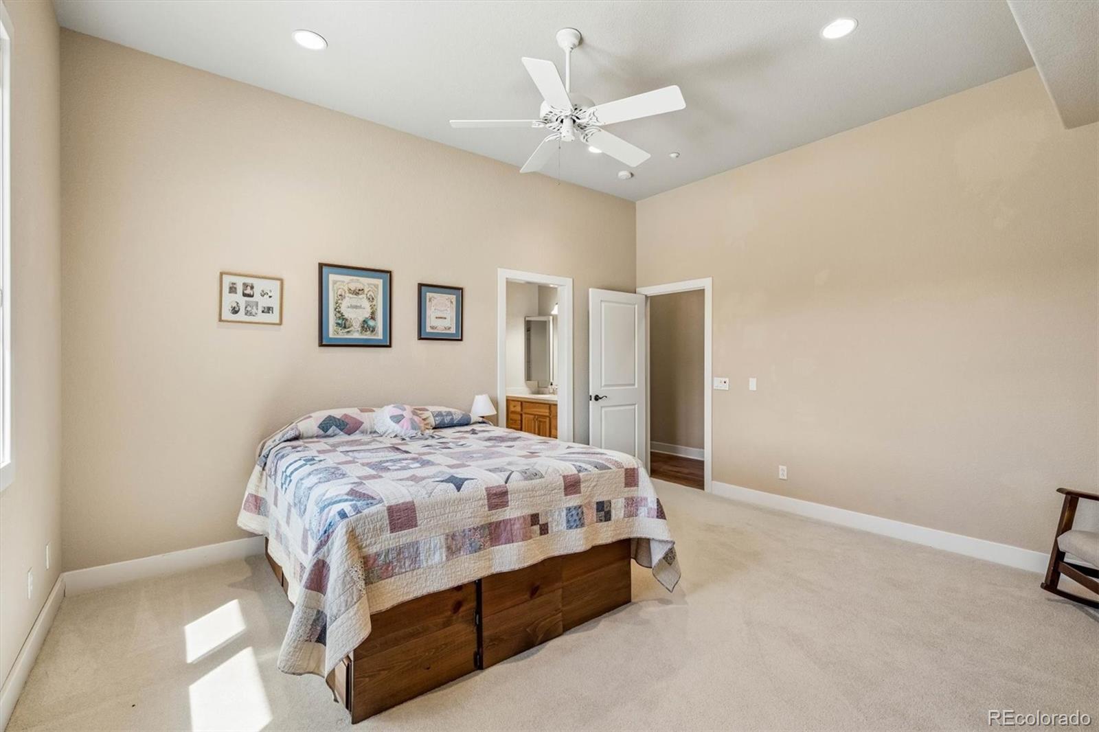 3959 Serenade Road Castle Rock, CO 80104 - Photo 32 of 50 a bedroom with a bed and a ceiling fan