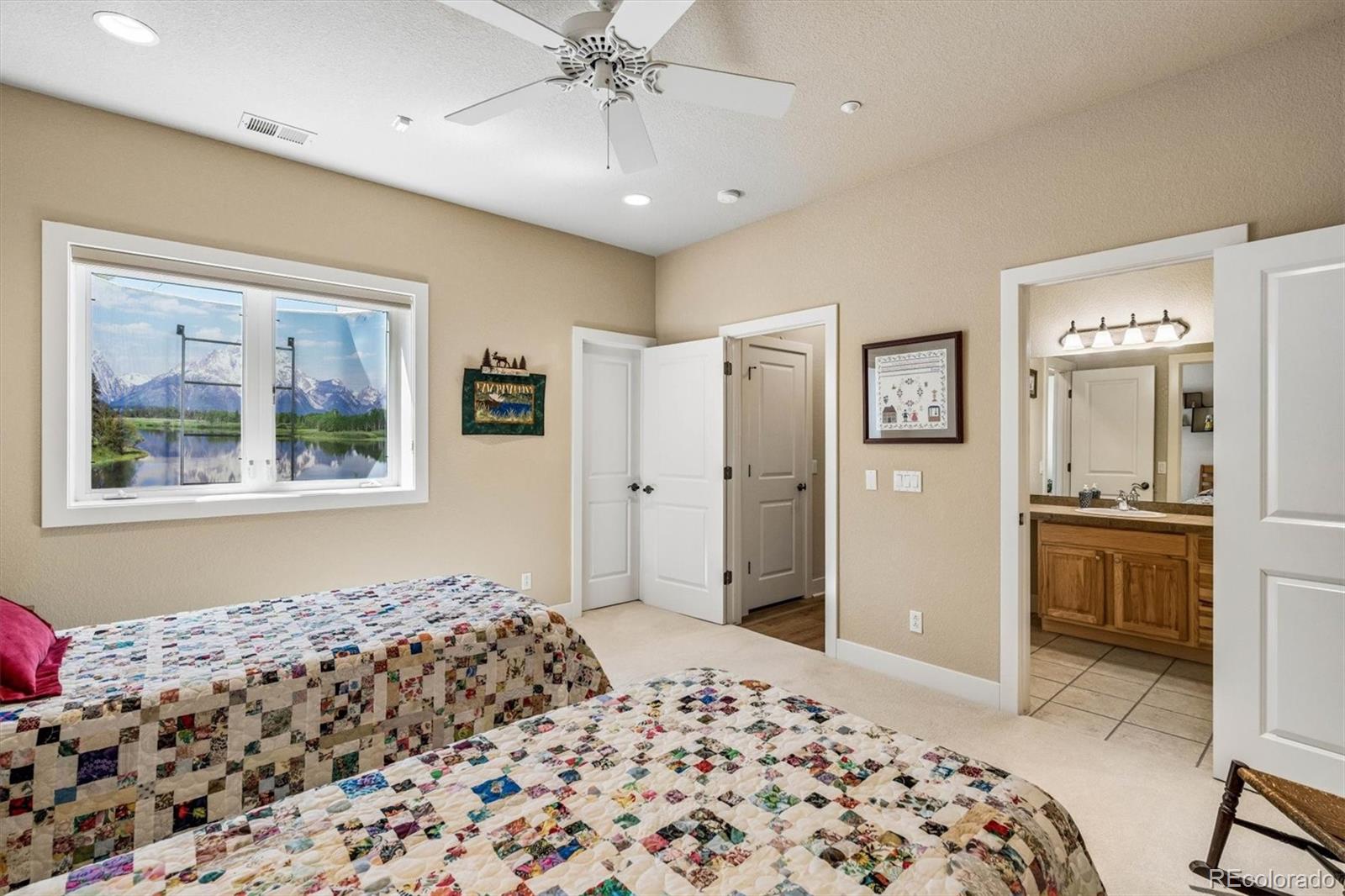 3959 Serenade Road Castle Rock, CO 80104 - Photo 35 of 50 a bedroom with a bed and a chandelier