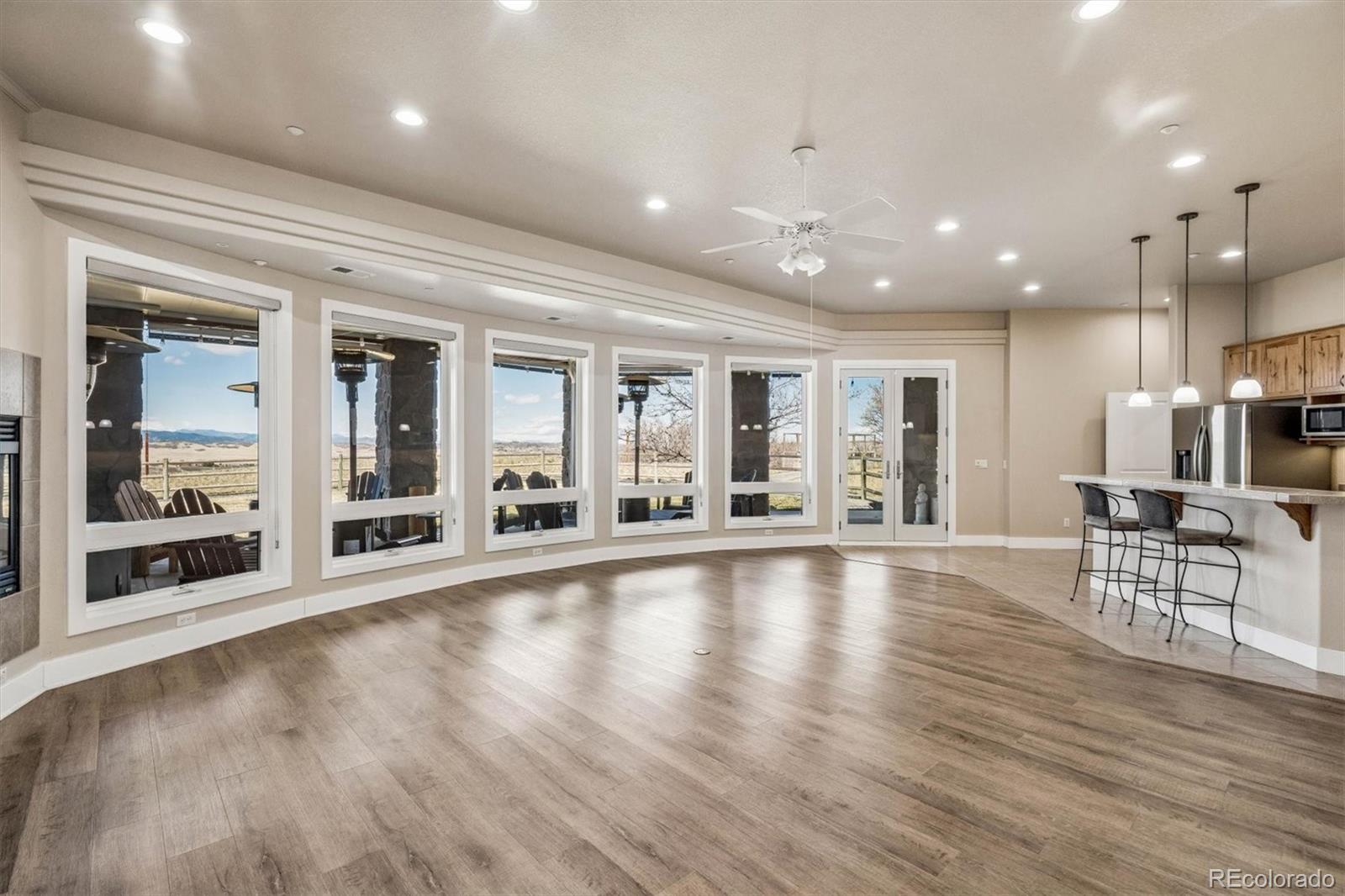 3959 Serenade Road Castle Rock, CO 80104 - Photo 37 of 50 a view of an empty room with kitchen and dining area a chandelier