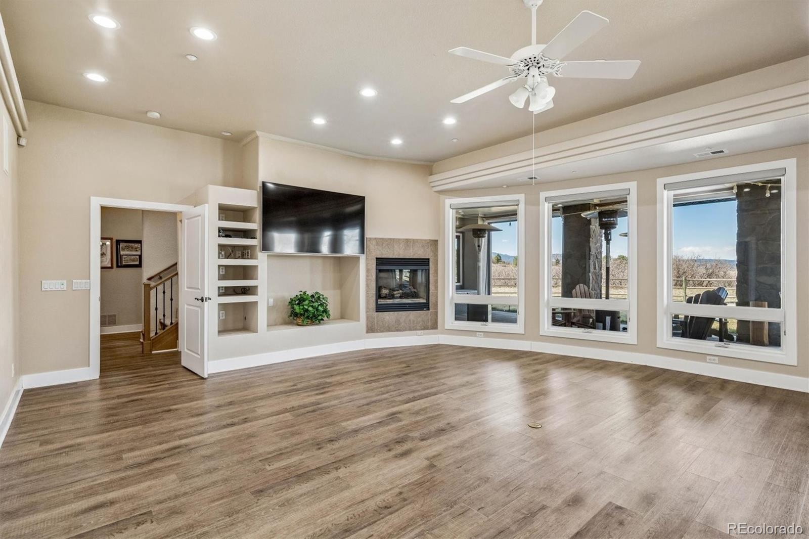 3959 Serenade Road Castle Rock, CO 80104 - Photo 38 of 50 a view of a big room with wooden floor and a ceiling fan