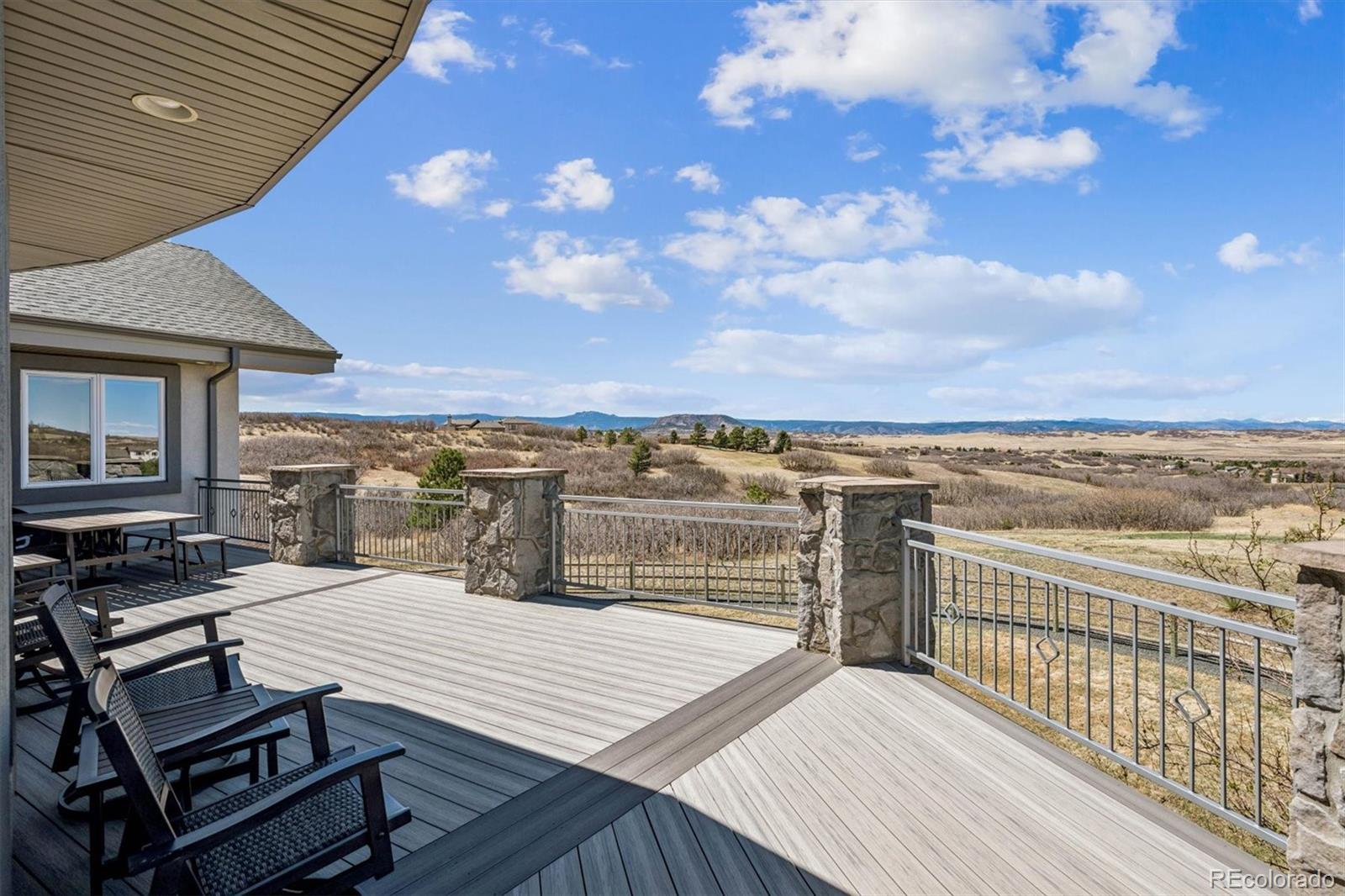 3959 Serenade Road Castle Rock, CO 80104 - Photo 44 of 50 a view of a terrace with wooden floor and city view