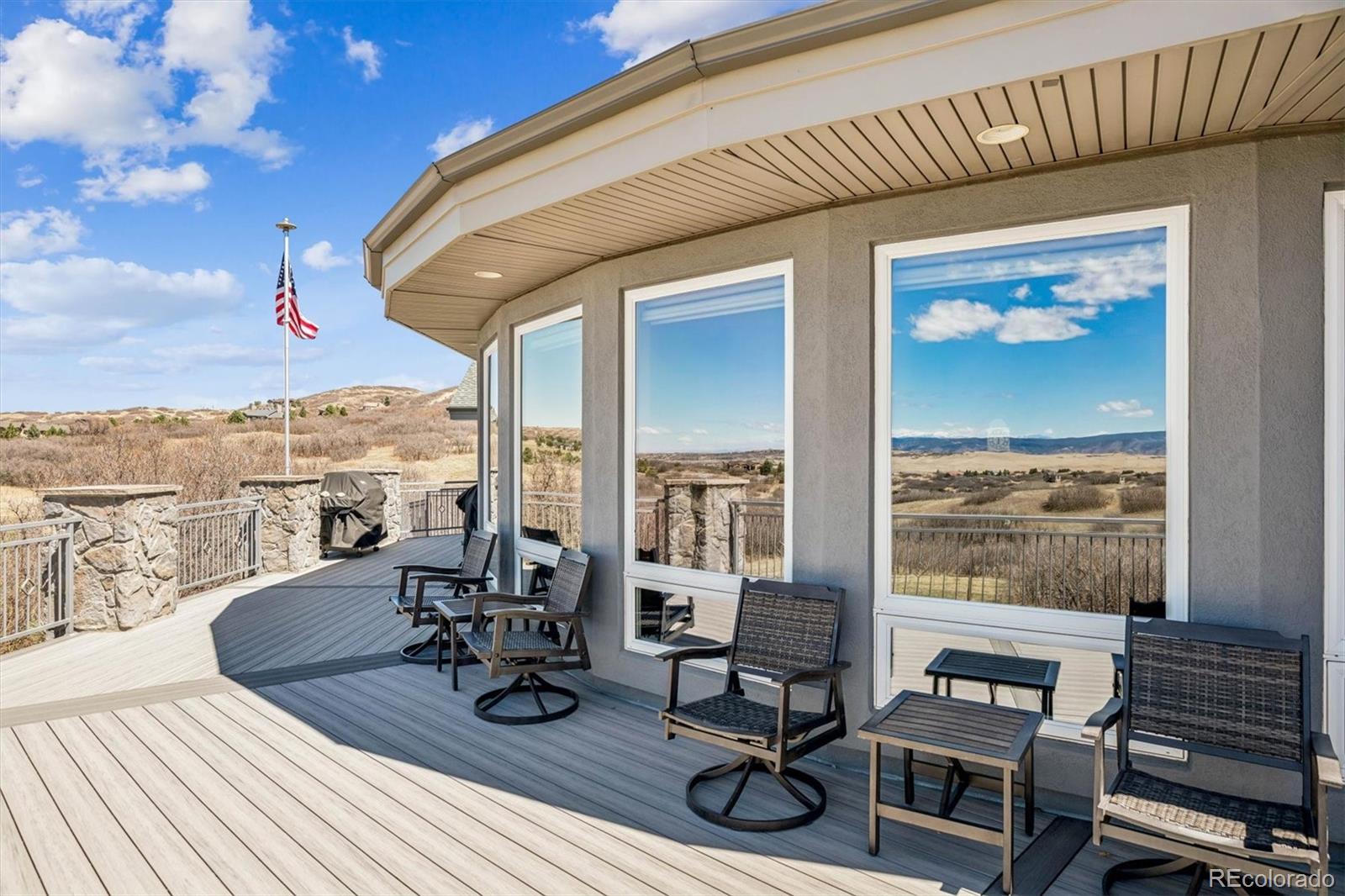3959 Serenade Road Castle Rock, CO 80104 - Photo 46 of 50 a view of a patio with chairs and wooden floor