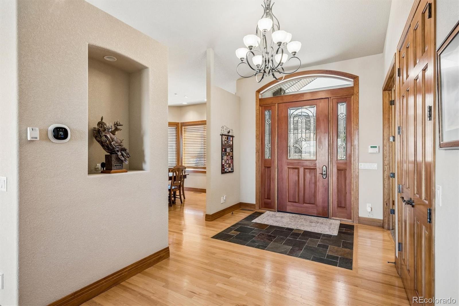 3959 Serenade Road Castle Rock, CO 80104 - Photo 7 of 50 a view of a hallway with wooden floor and staircase