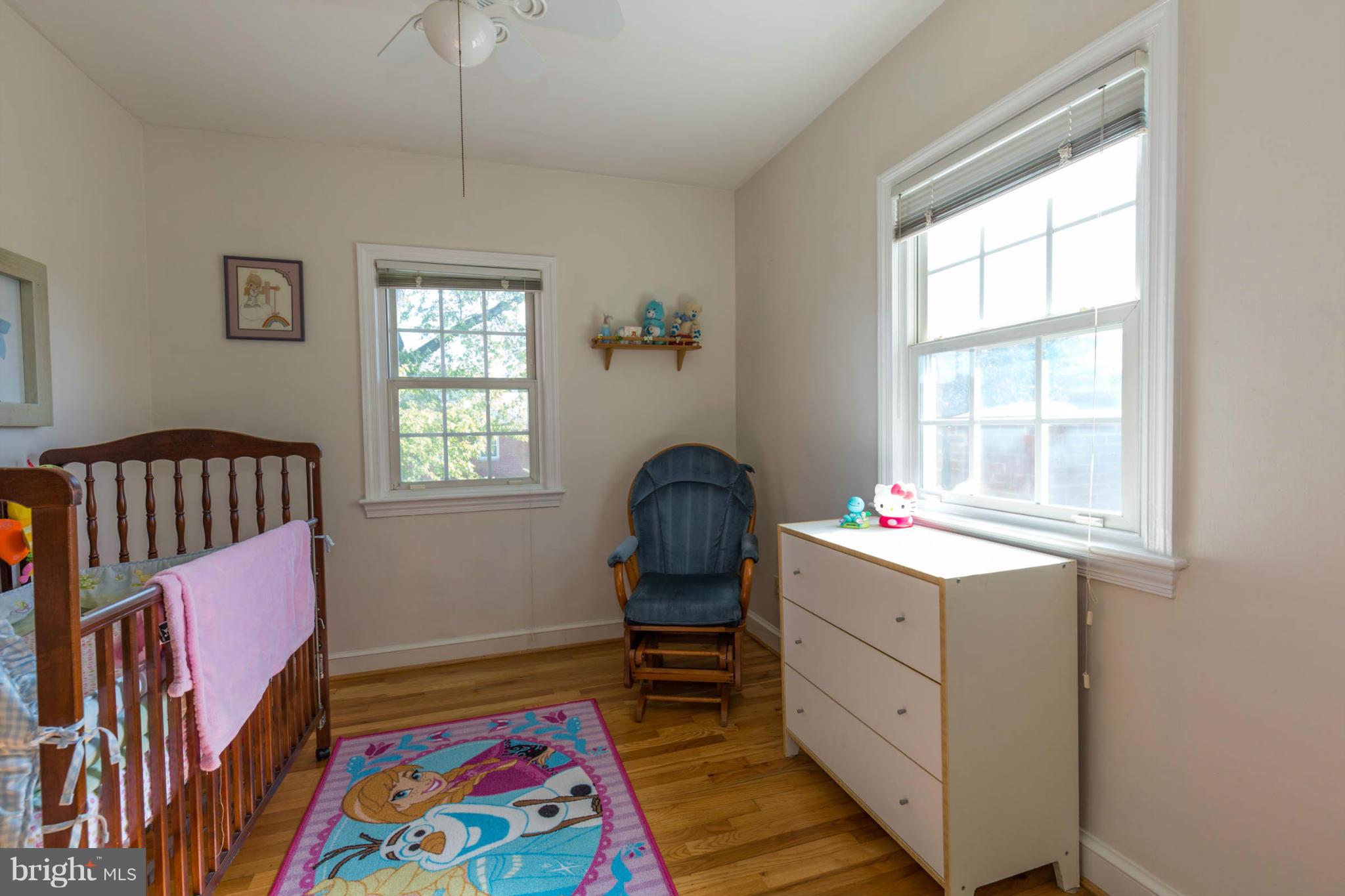 207 Indian Spring Drive Silver Spring, MD 20901 - Photo 21 of 30 a bedroom with a bed and wooden floor