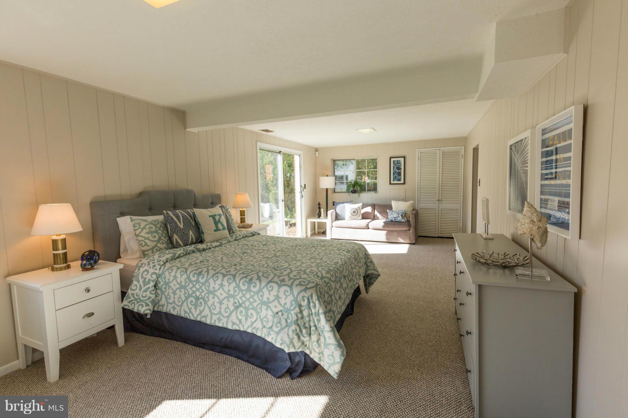 207 Indian Spring Drive Silver Spring, MD 20901 - Photo 23 of 30 a spacious bedroom with a bed and wooden floor