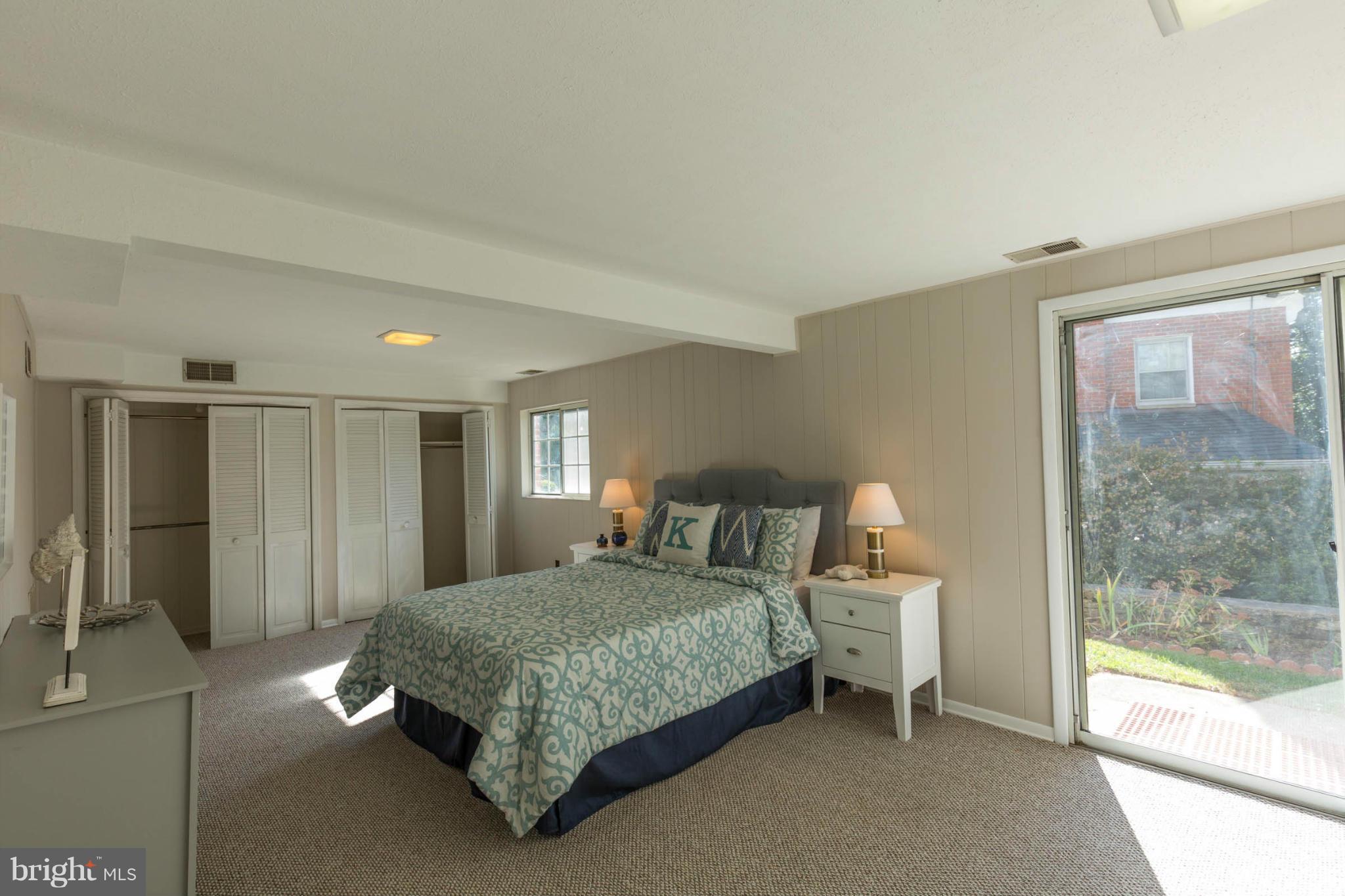 207 Indian Spring Drive Silver Spring, MD 20901 - Photo 24 of 30 a bedroom with a bed lamp and a large window