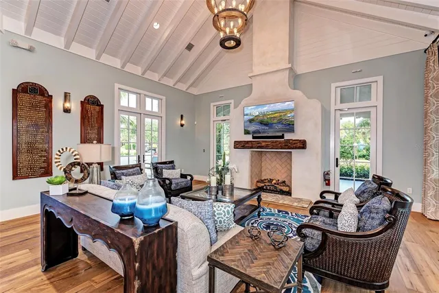 a living room with furniture a fireplace and wooden floor